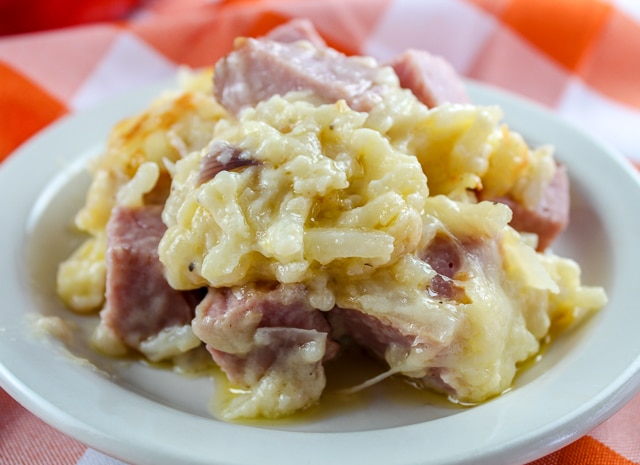 Cheesy Potatoes and Ham are so easy and delicious! You'll love the flavor from the Jarlsberg cheese and the creaminess from the sauce! Leftover ham never tasted so good!