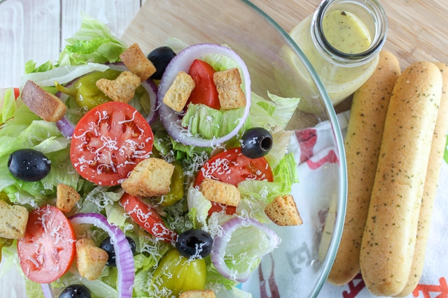 Olive Garden House Salad is literally the best restaurant salad! It has all your favorite toppings like olives and tomatoes and topped with that delicious and tangy dressing and I have the recipe to share with you!