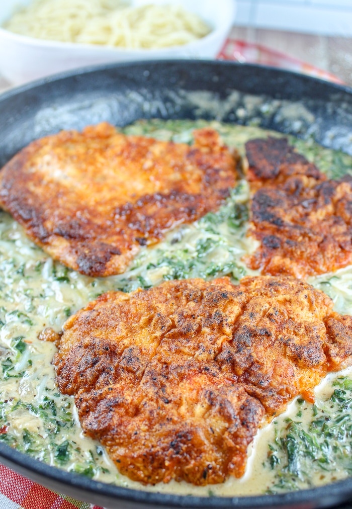 Creamy Garlic Spinach Pork Chops are delicious! These tender pork chops with this creamy garlic spinach sauce are all made in one skillet and ready in less than 30 minutes. via @foodhussy