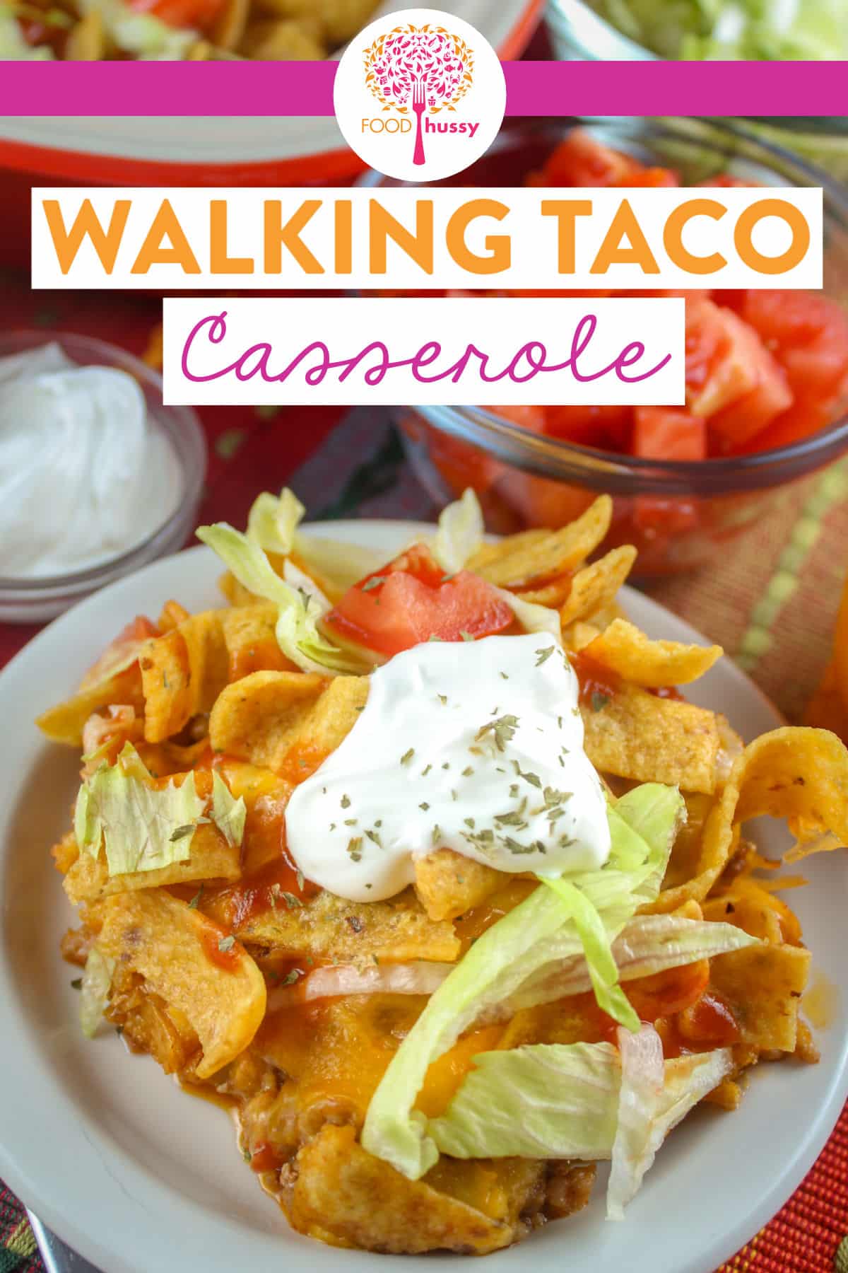 Walking Taco Casserole will bring back the memories of Walking Tacos! This casserole is packed with taco meat, cheese, lettuce, tomatoes, sour cream & chips! via @foodhussy