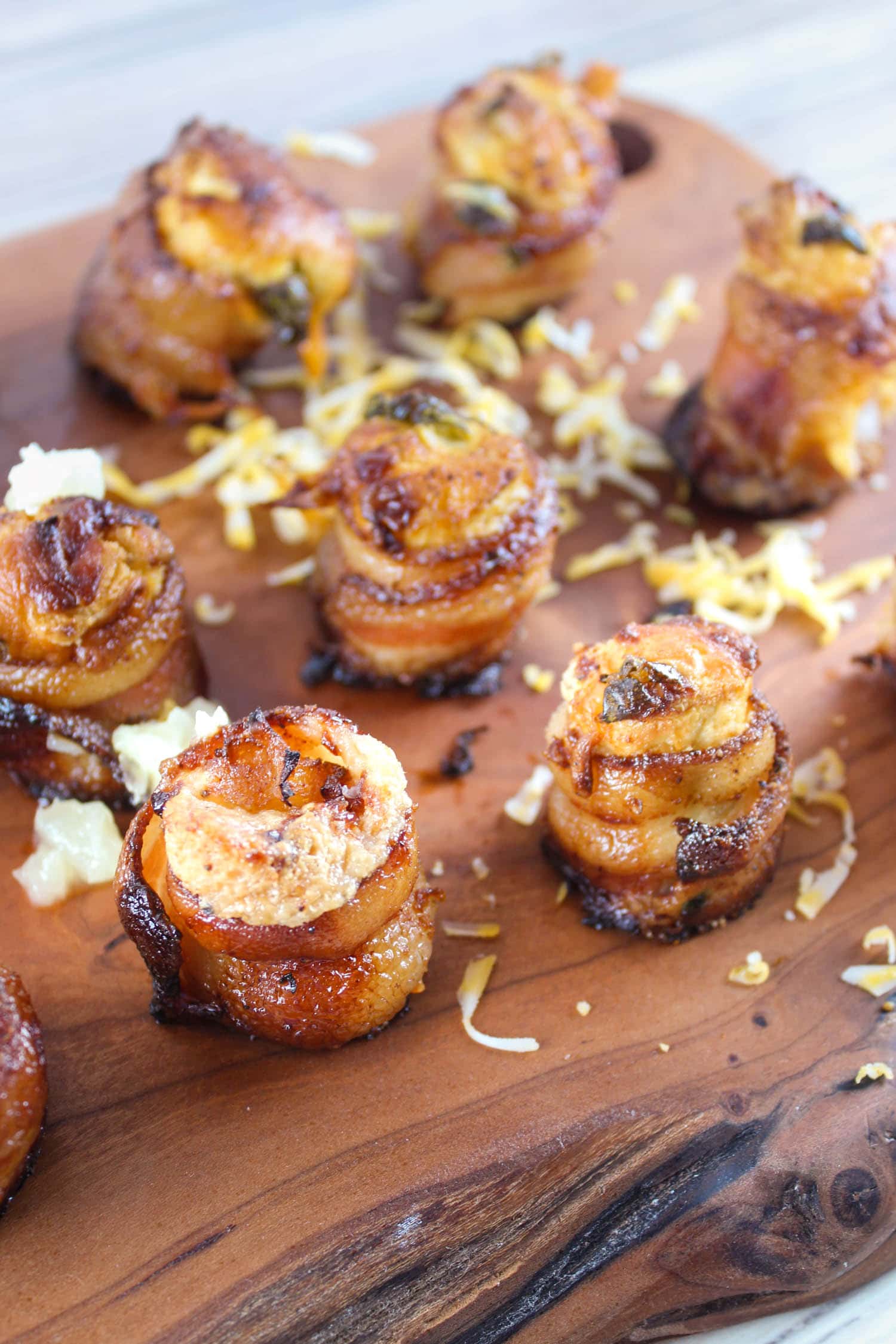 Smoked Pig Shots on the Traeger are the latest and greatest appetizer! Bacon "shot glasses" filled with smoked sausage, cream cheese and more! These are great for any summer barbecue, tailgating or holiday get-together. via @foodhussy