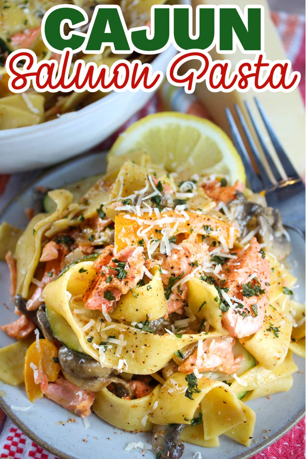 This Cajun Salmon Pasta is done in the amount of time it takes to make your pasta! It's quick, creamy, full of your favorite veggies and delicious! Juicy chunks of flaky salmon tossed in a spicy cream sauce over pappardelle noodles - it will be your new favorite! via @foodhussy