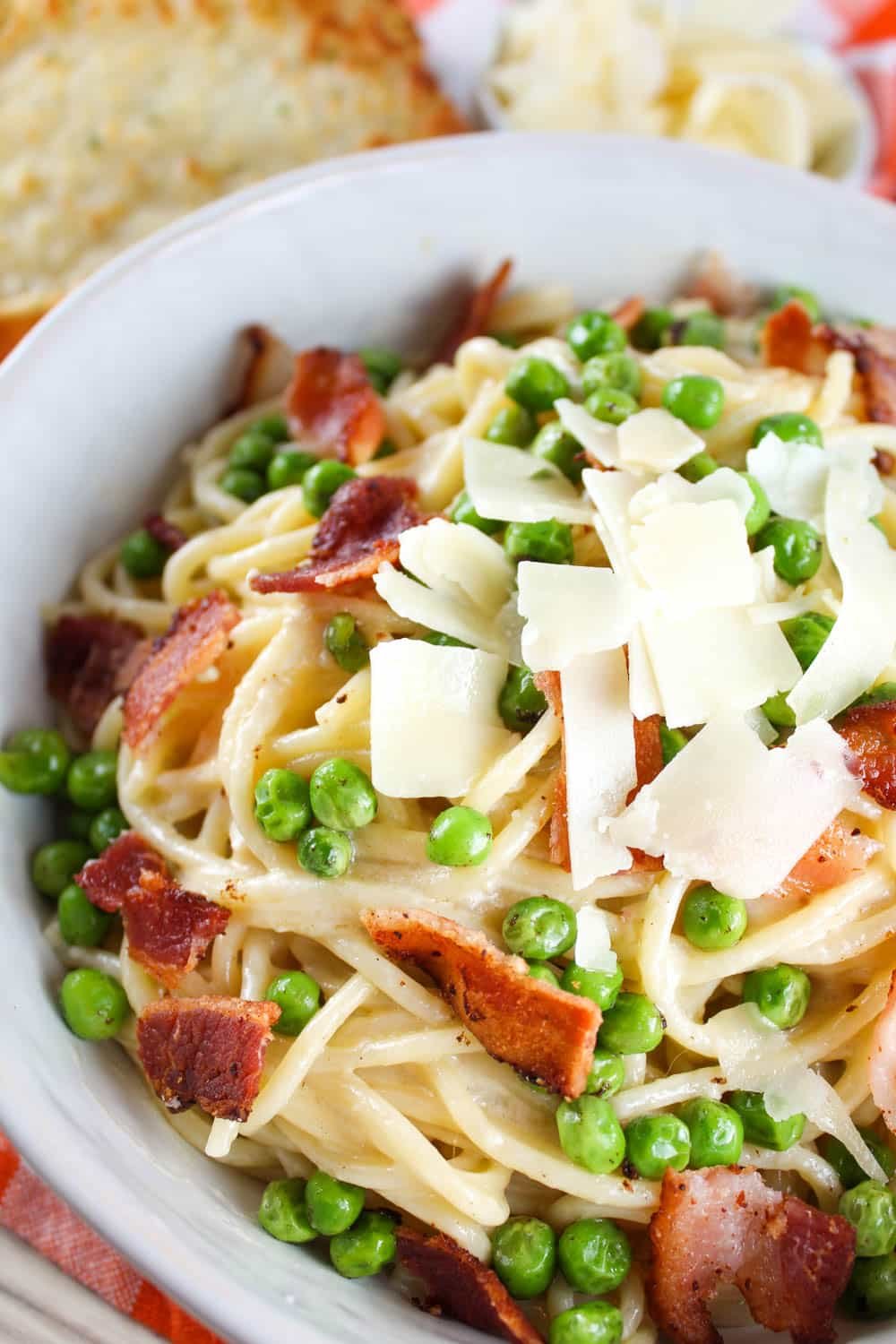 Cheesecake Factory's Pasta Carbonara recipe is creamy and on the table in less than 30 minutes! Spaghetti coated in a light carbonara sauce and topped with peas and thick cut bacon. It's my favorite!! via @foodhussy