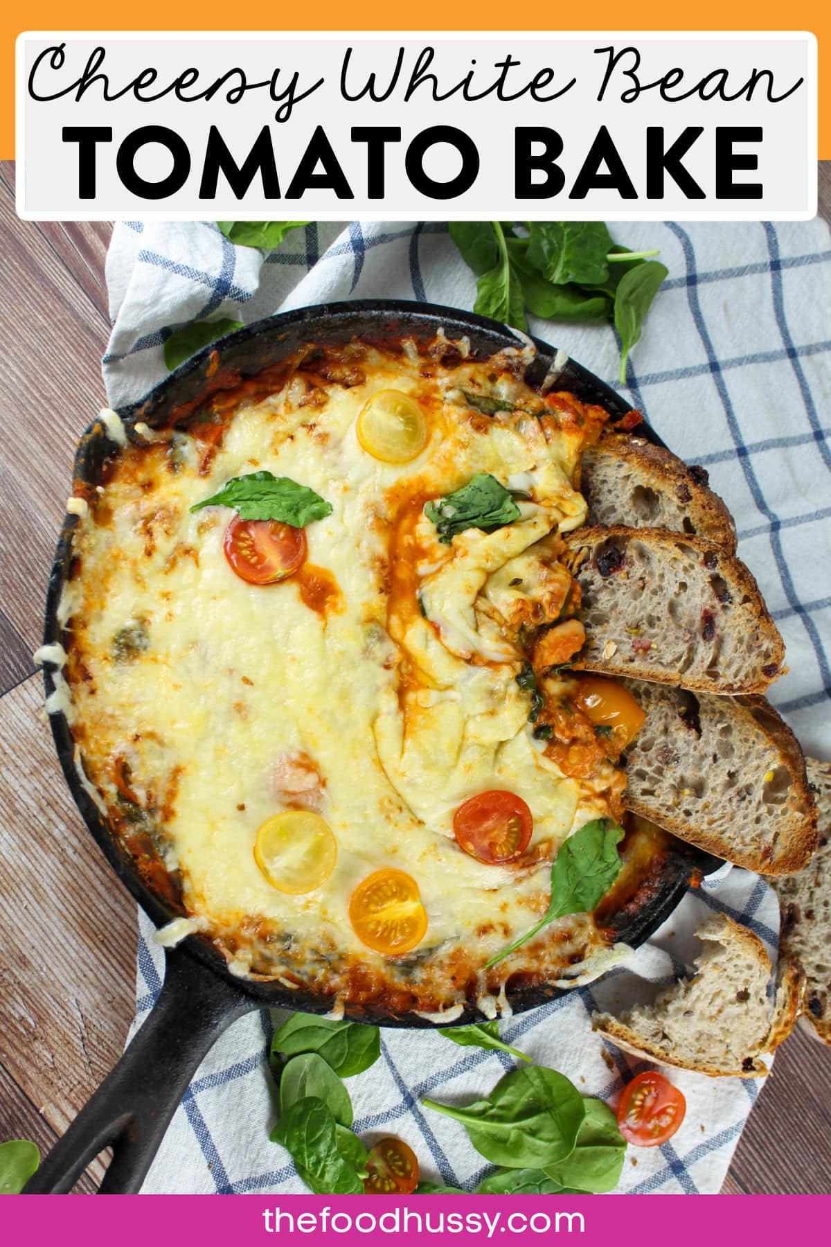 Cheesy White Bean Tomato Bake is a great appetizer or vegetarian one-pan dinner that the whole family will enjoy! Dip your favorite crusty bread into this cheesy dip chock full of warm white beans, fresh tomatoes and a great garlicky aroma! via @foodhussy