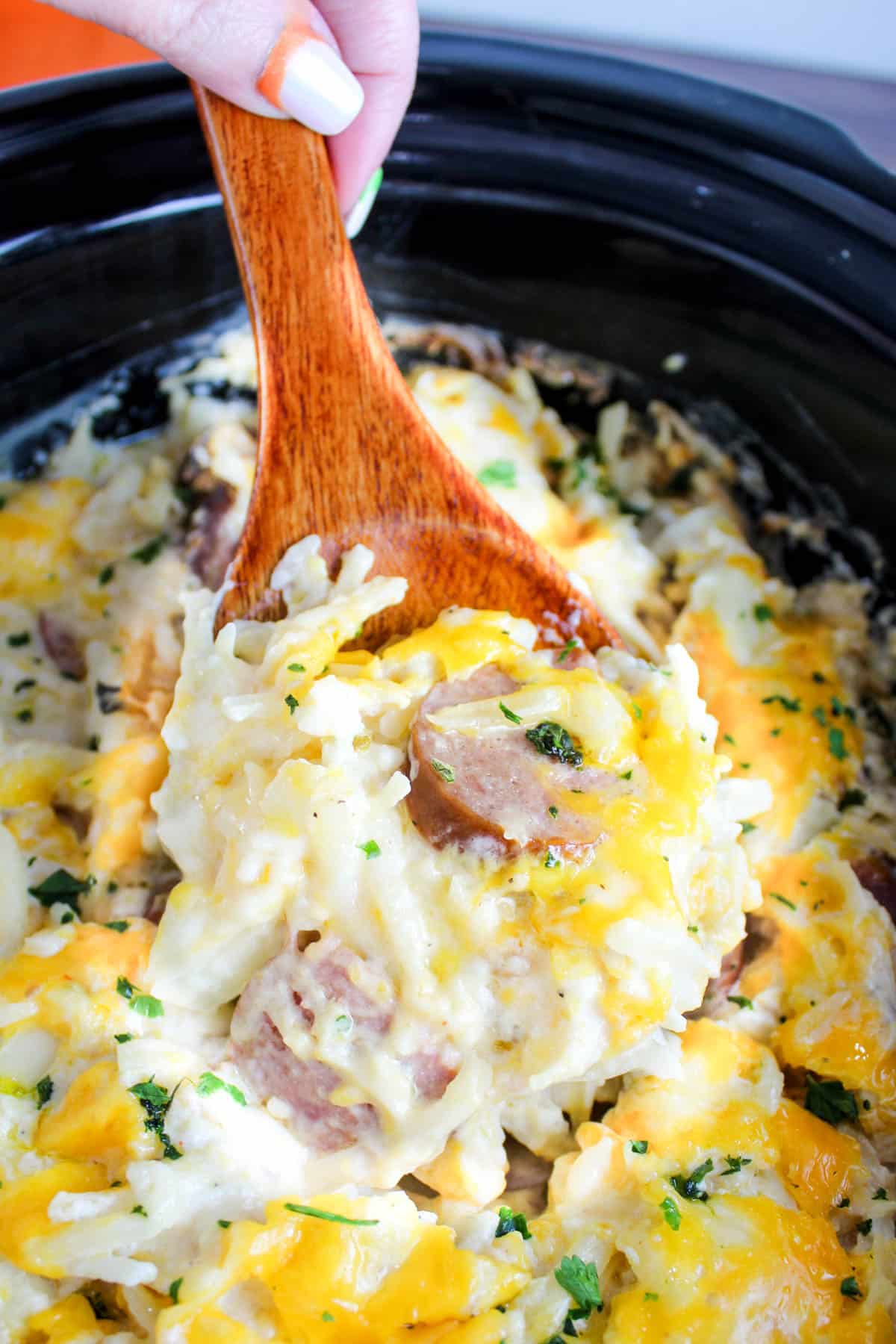 This Sausage Casserole in a Slow Cooker is so warm and comforting. Hash brown potatoes loaded up with sour cream, cheddar and pepper jack cheeses and lightly smoky sliced kielbasa.  via @foodhussy