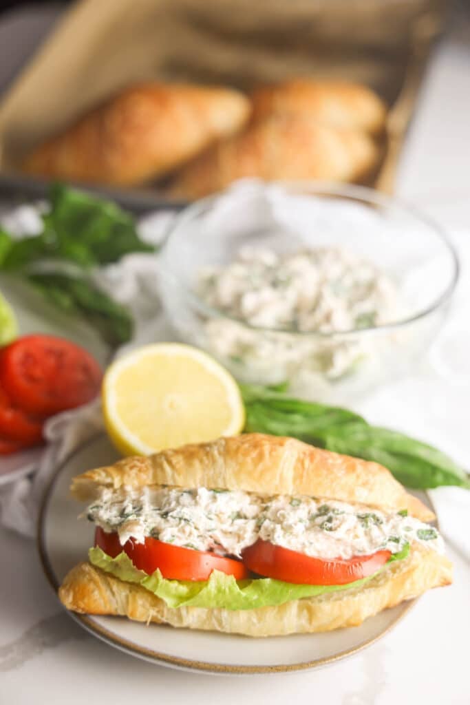 Lauryn's Lemon Basil chicken salad sandwich on a croissant with lettuce and tomato