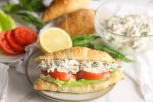 Lauryn's Lemon Basil chicken salad sandwich on a croissant with lettuce and tomato