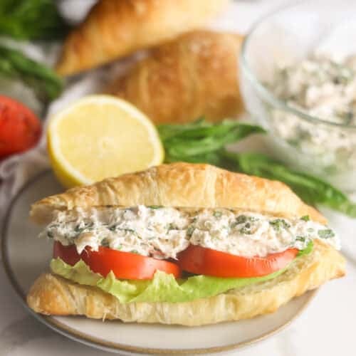 Lauryn's Lemon Basil chicken salad sandwich on a croissant with lettuce and tomato