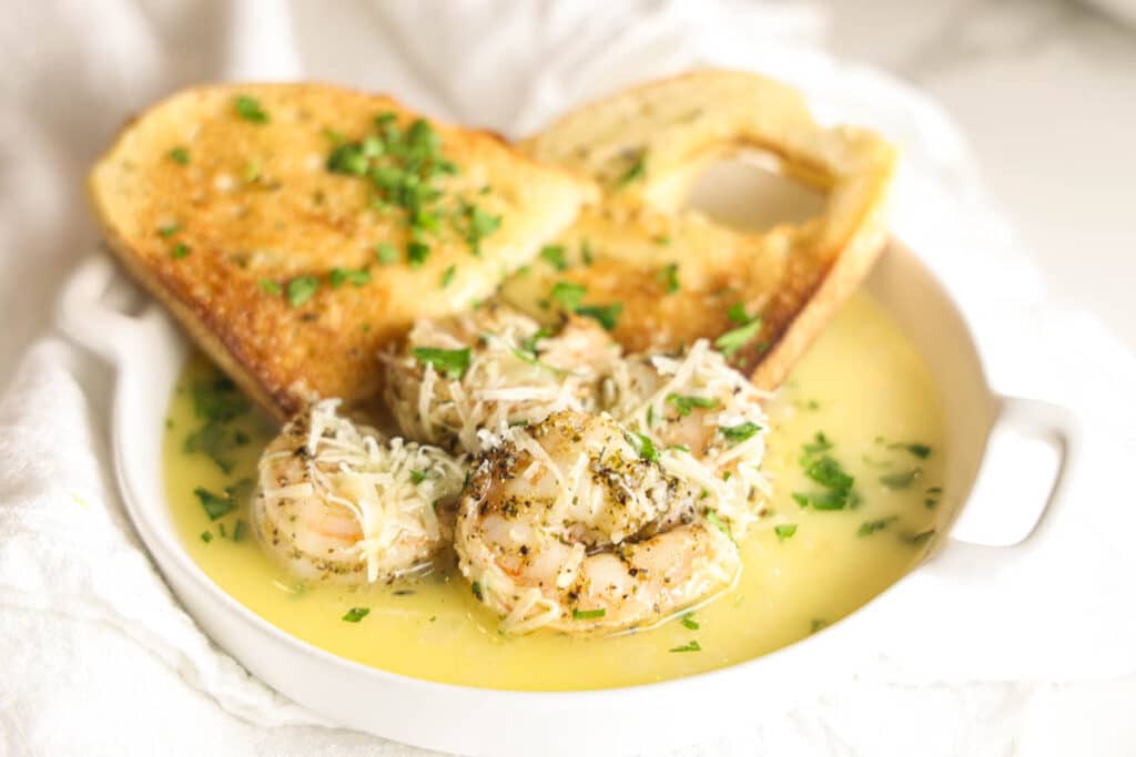 Close-up of copycat Carrabba's Shrimp Scampi shrimp topped with Parmesan and fresh parsley