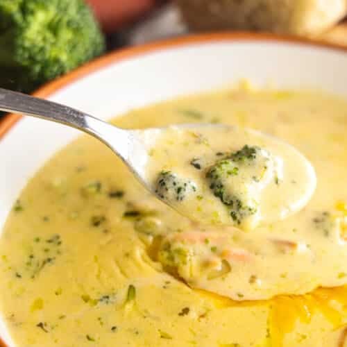 Spoonful of copycat Panera Broccoli Cheddar Soup with broccoli and carrots