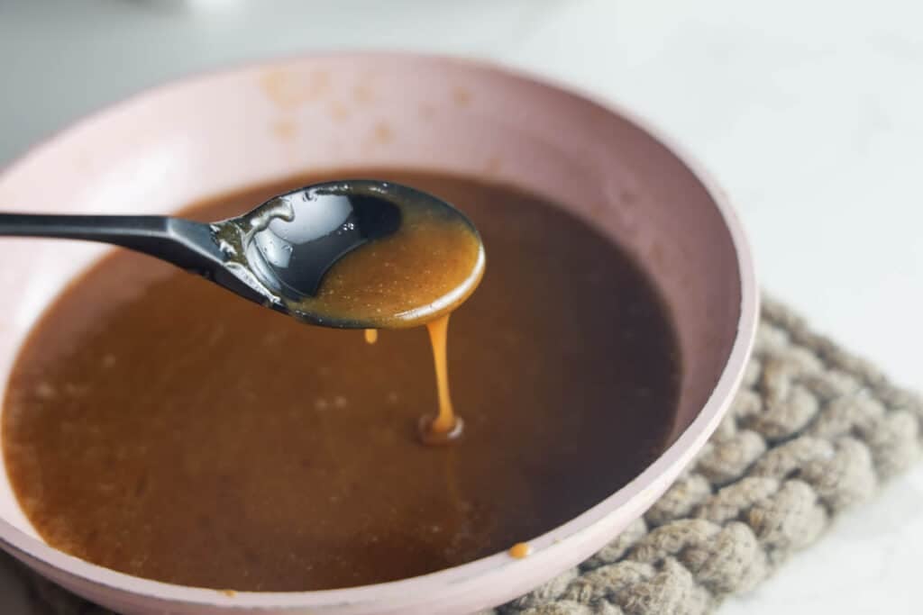 Honey cinnamon caramel sauce in a small saute pan for Texas Roadhouse sweet potatoes.