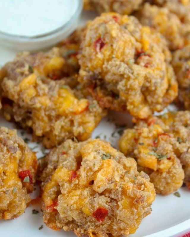 Pimento Cheese Sausage Balls are so tasty and I think the best version of sausage balls. If you haven’t had them before – now’s the time to make them! This is a great recipe for a quick and party food favorite – but they also reheat really well. #appetizers #partyfood #foodblogger #easyrecipes