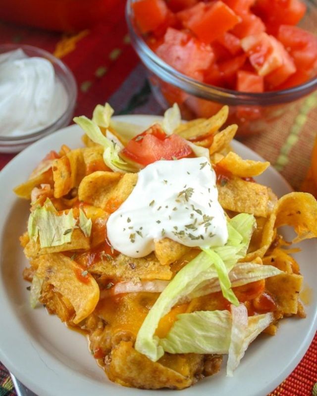 Walking Taco Casserole! It’s got all the yum of that original walking taco – taco meat, cheese, lettuce, sour cream and, of course, chips! You can use which ever your favorite is – I went for Fritos – but Cool Ranch Doritos are never a mistake either! #walkingtaco #casserole #foodideas #dinnerideas #easymeals #cookingathome #fyp